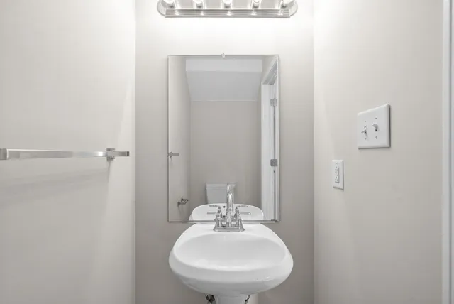 a bathroom with a sink and mirror
