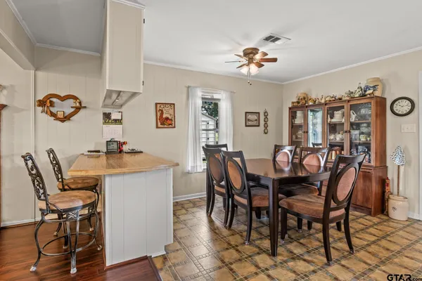 a dining room with furniture and chandelier