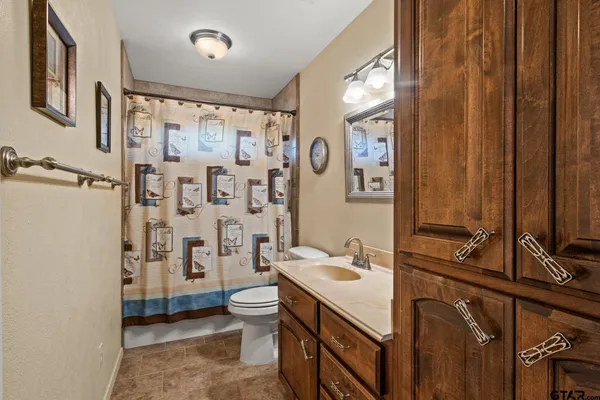 a bathroom with a double vanity sink toilet and shower