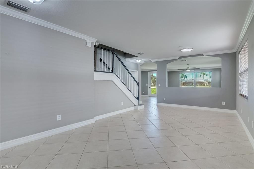 1654 Double Eagle Trail Naples, FL 34120 - Photo 15 of 48 Living room with ornamental molding, ceiling fan, and light tile patterned flooring