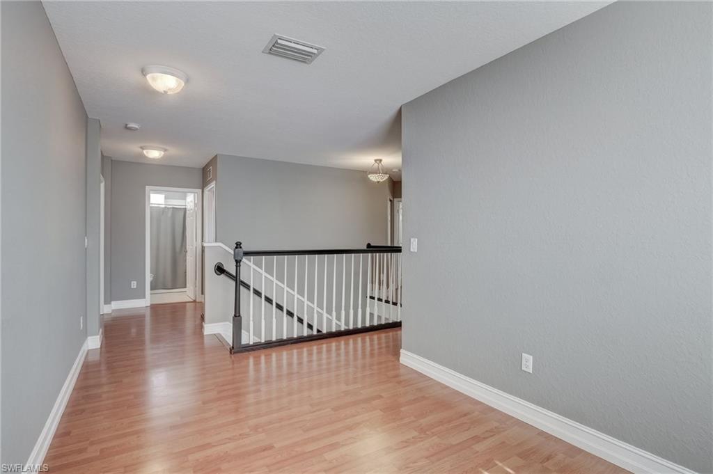 1654 Double Eagle Trail Naples, FL 34120 - Photo 23 of 48 Corridor featuring hardwood / wood-style flooring