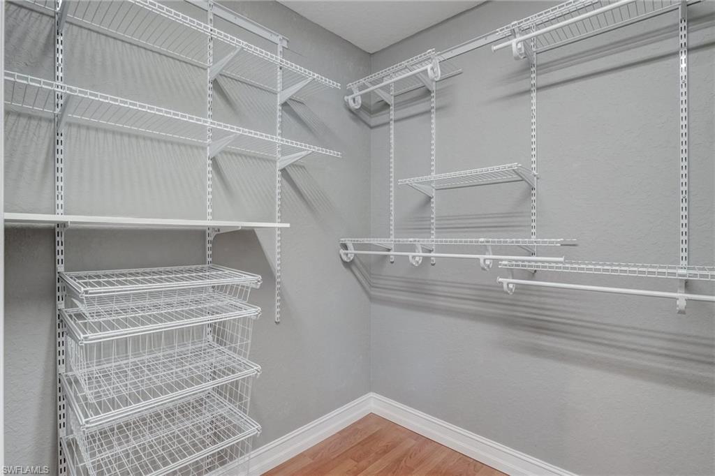 1654 Double Eagle Trail Naples, FL 34120 - Photo 32 of 48 Walk in closet featuring wood-type flooring