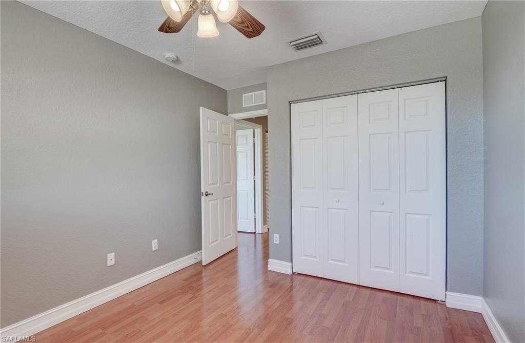 1654 Double Eagle Trail Naples, FL 34120 - Photo 43 of 48 Bedroom featuring light hardwood / wood-style flooring, ceiling fan, and a closet