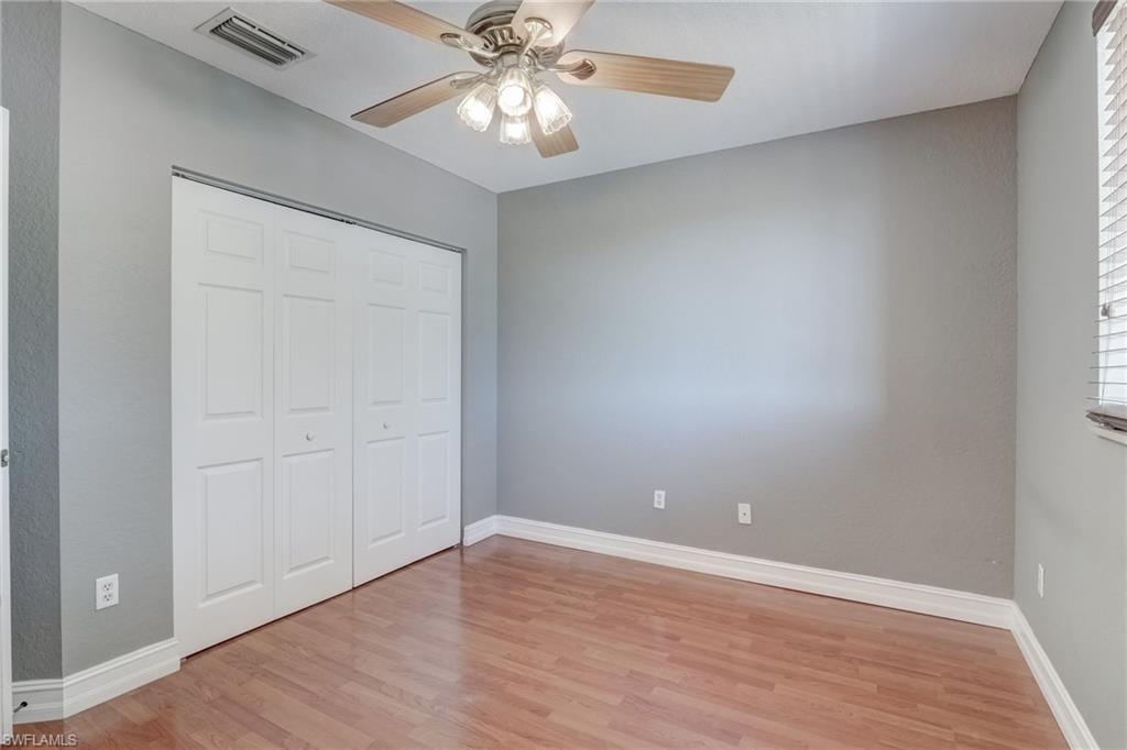 1654 Double Eagle Trail Naples, FL 34120 - Photo 45 of 48 Bedroom featuring light hardwood / wood-style floors, ceiling fan, and a closet