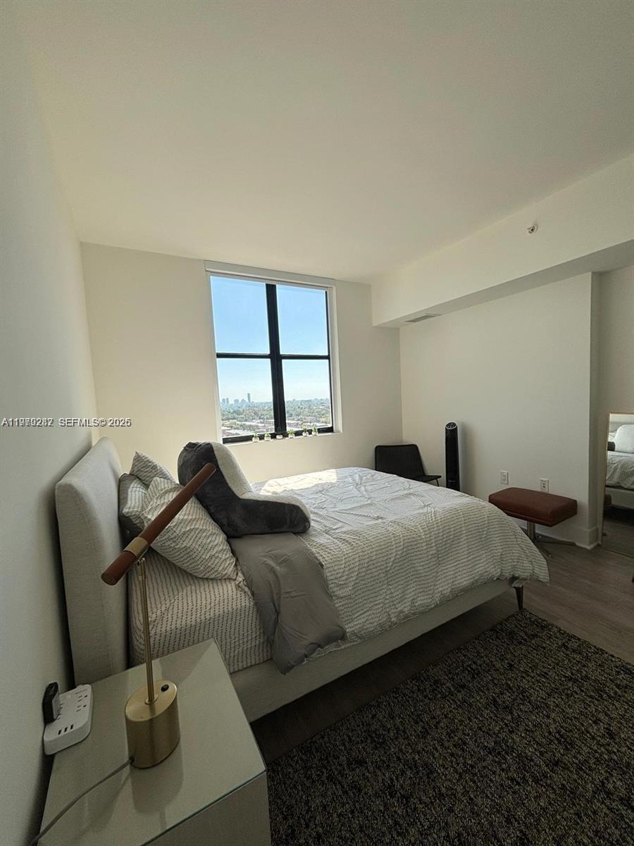 888 Douglas Road, Unit 1002 Coral Gables, FL 33134 - Photo 17 of 34 a bedroom with bed and window