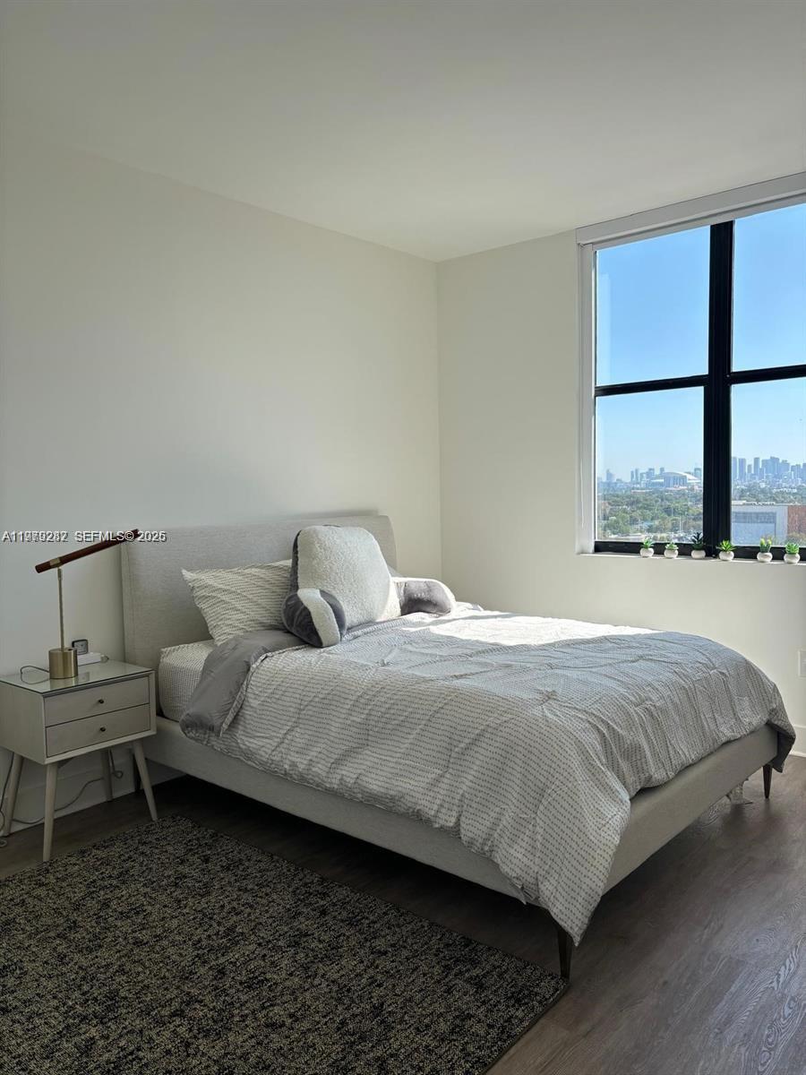 888 Douglas Road, Unit 1002 Coral Gables, FL 33134 - Photo 18 of 34 a bedroom with a bed and window