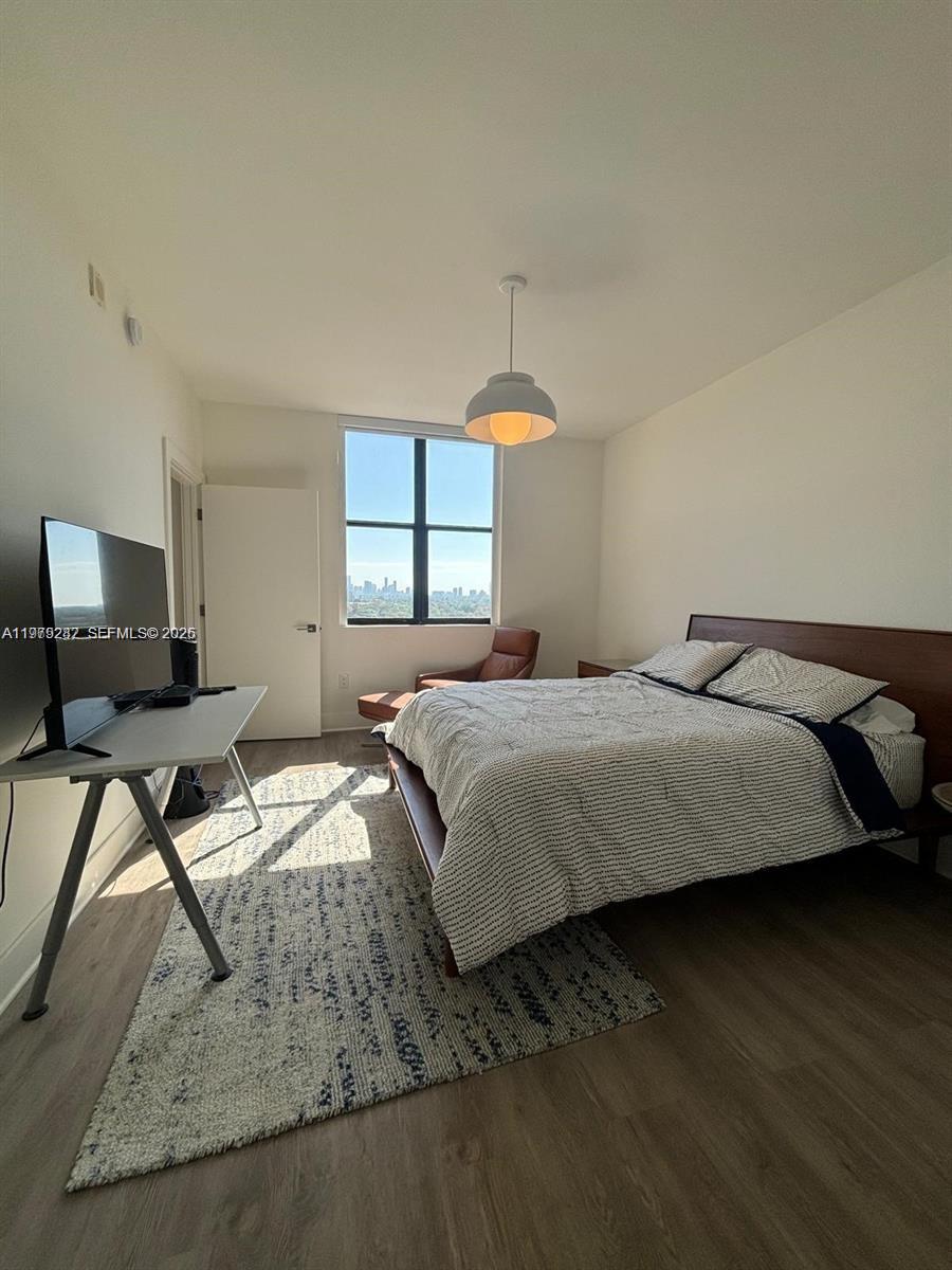 888 Douglas Road, Unit 1002 Coral Gables, FL 33134 - Photo 2 of 34 a bedroom with a bed and a table