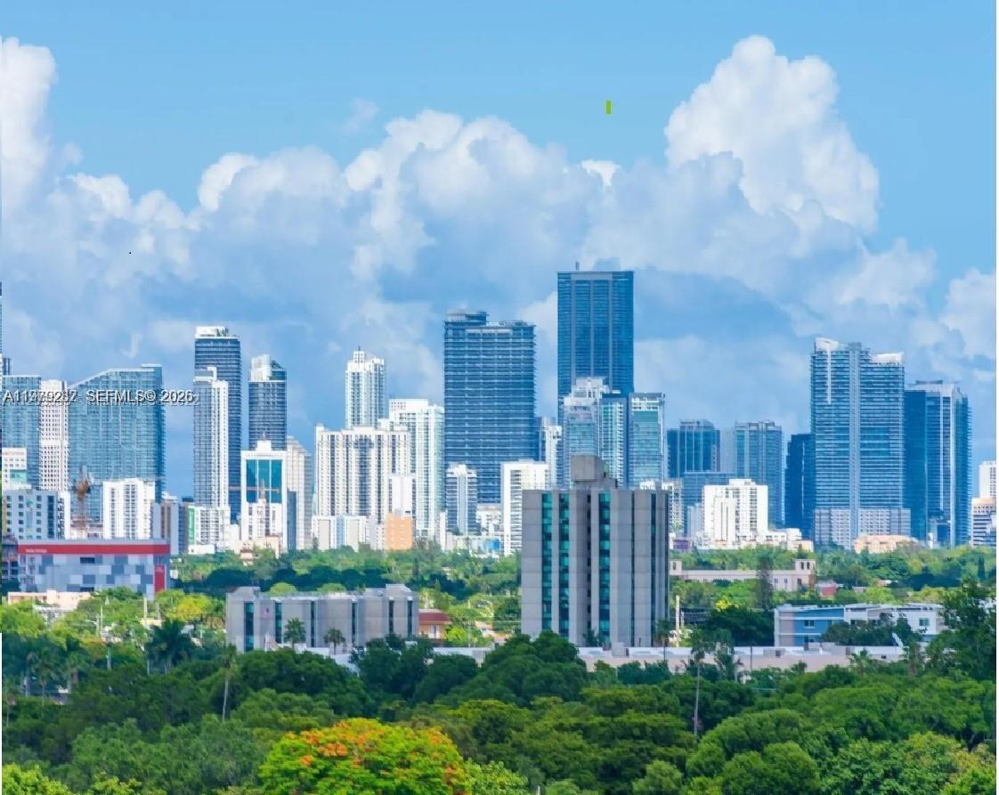 888 Douglas Road, Unit 1002 Coral Gables, FL 33134 - Photo 26 of 34 a view of a city with tall buildings and a big yard