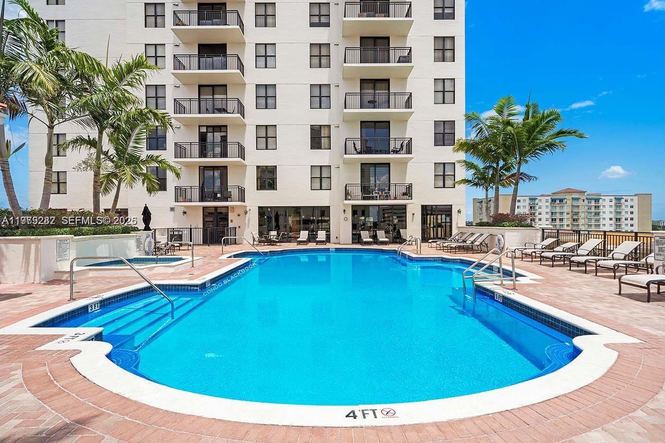 888 Douglas Road, Unit 1002 Coral Gables, FL 33134 - Photo 31 of 34 a swimming pool with outdoor seating and yard
