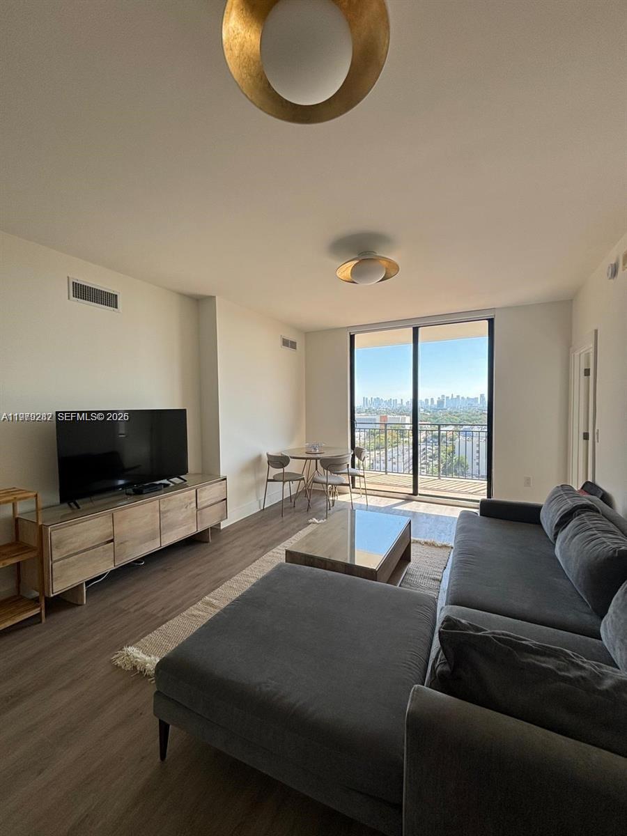 888 Douglas Road, Unit 1002 Coral Gables, FL 33134 - Photo 10 of 34 a living room with furniture and a flat screen tv