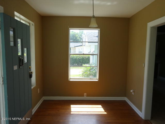 9765 Cunningham Road Jacksonville, FL 32246 - Photo 3 of 13 a view of empty room with wooden floor and fan