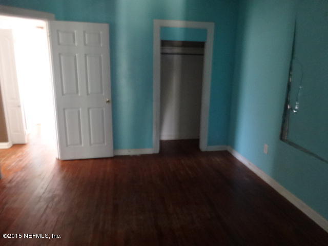 9765 Cunningham Road Jacksonville, FL 32246 - Photo 8 of 13 a view of a hallway with wooden floor