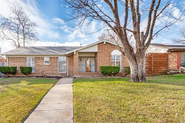 a view of a house with a large tree and a big yard