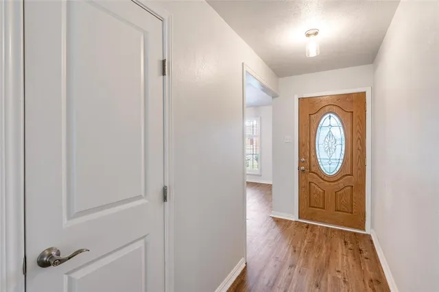 a view of an entryway with wooden floor