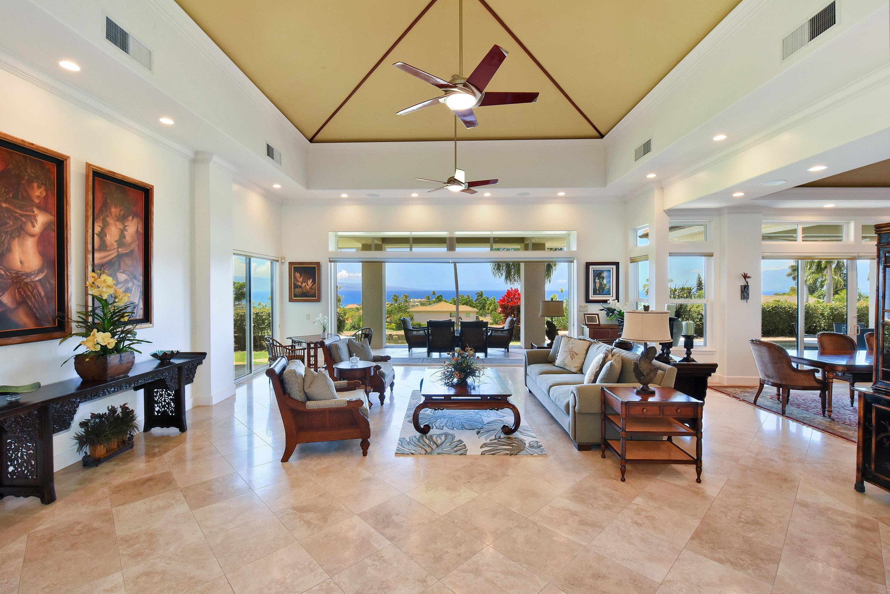 175 Ulukoa Place Lahaina, HI 96761 - Photo 12 of 50 a living room with furniture a chandelier and a large window