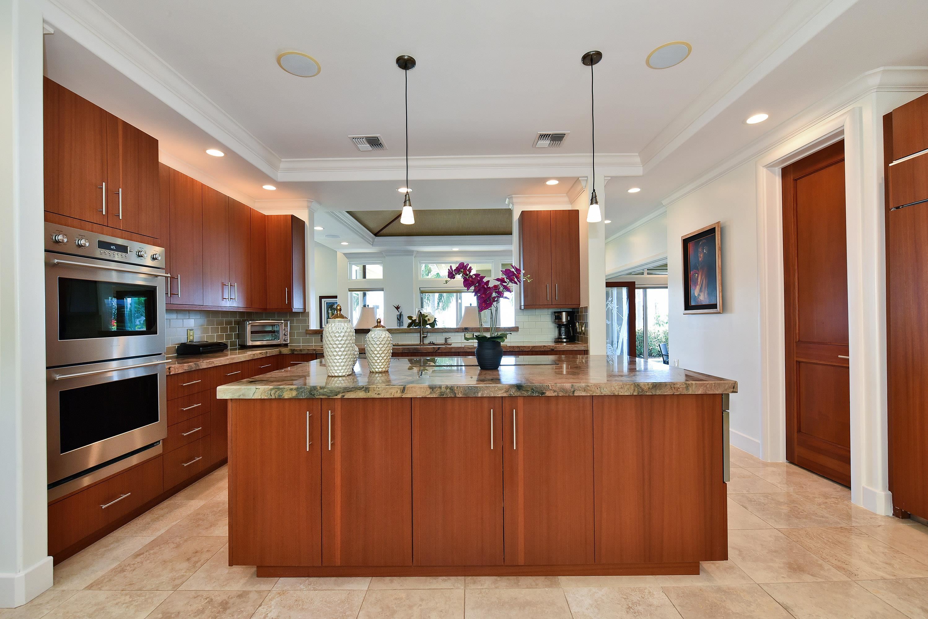 175 Ulukoa Place Lahaina, HI 96761 - Photo 18 of 50 a kitchen with kitchen island a counter top space a sink stainless steel appliances and cabinets