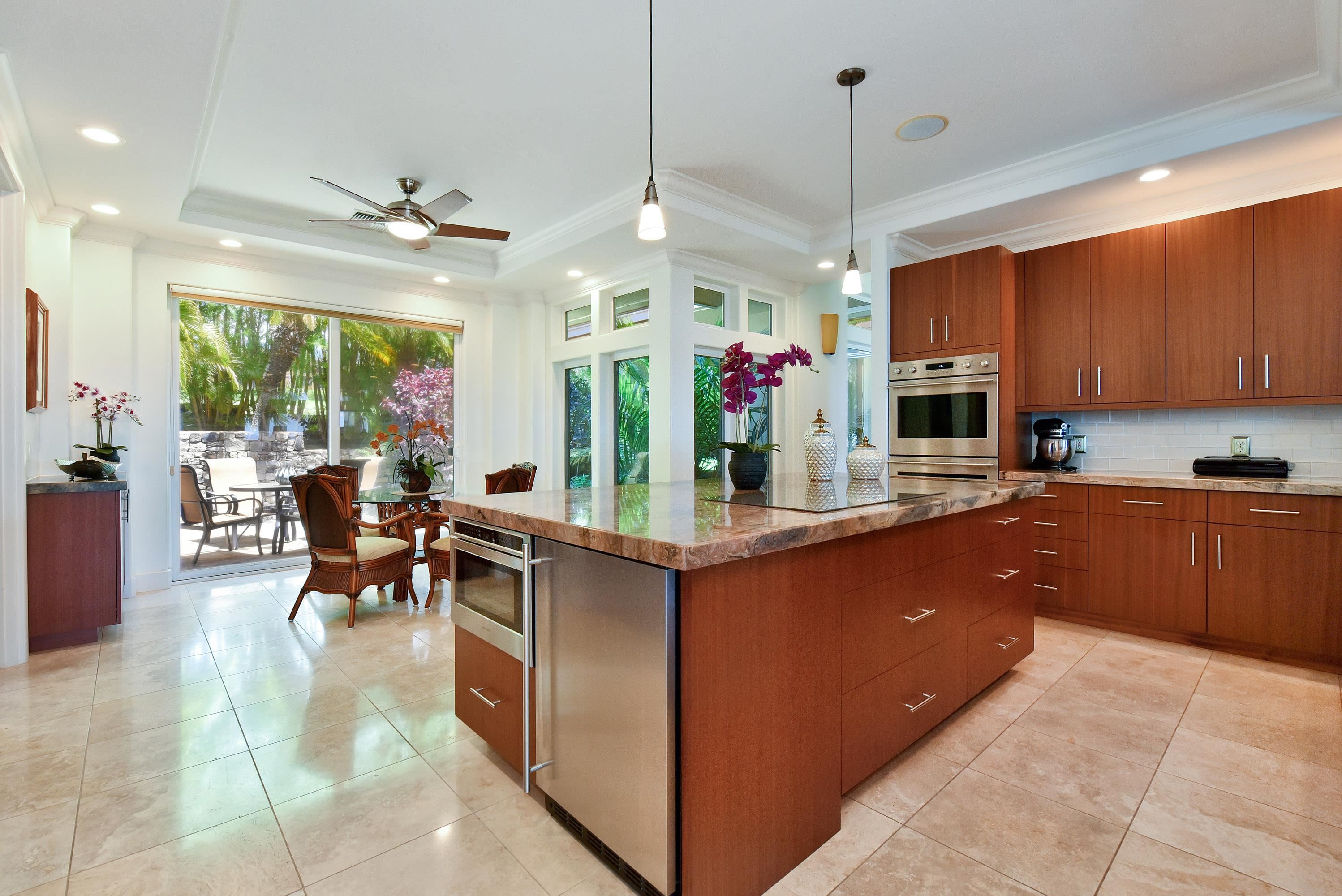 175 Ulukoa Place Lahaina, HI 96761 - Photo 21 of 50 a kitchen with stainless steel appliances kitchen island granite countertop a stove and cabinets