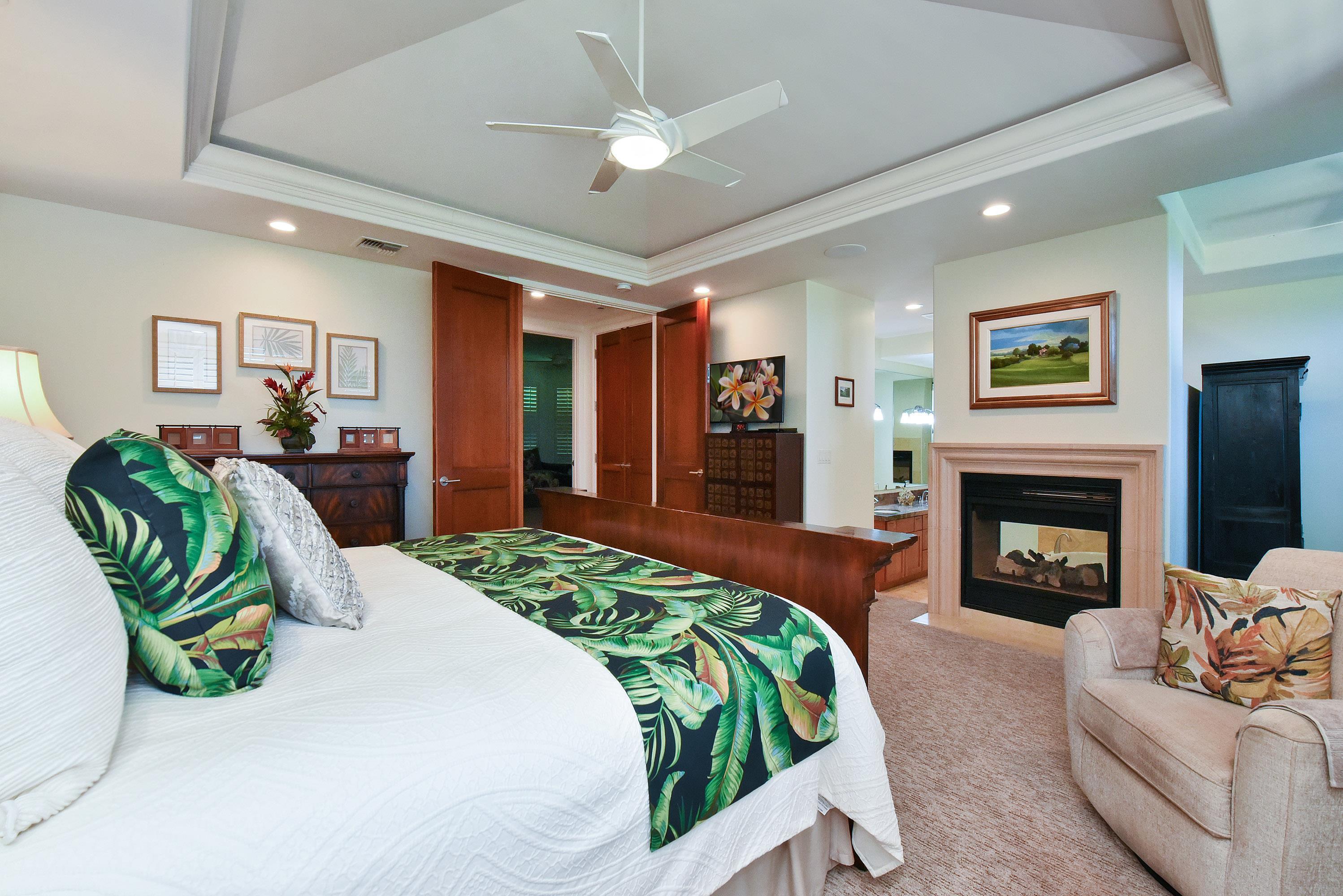 175 Ulukoa Place Lahaina, HI 96761 - Photo 27 of 50 a bedroom with a bed mirror and a fireplace