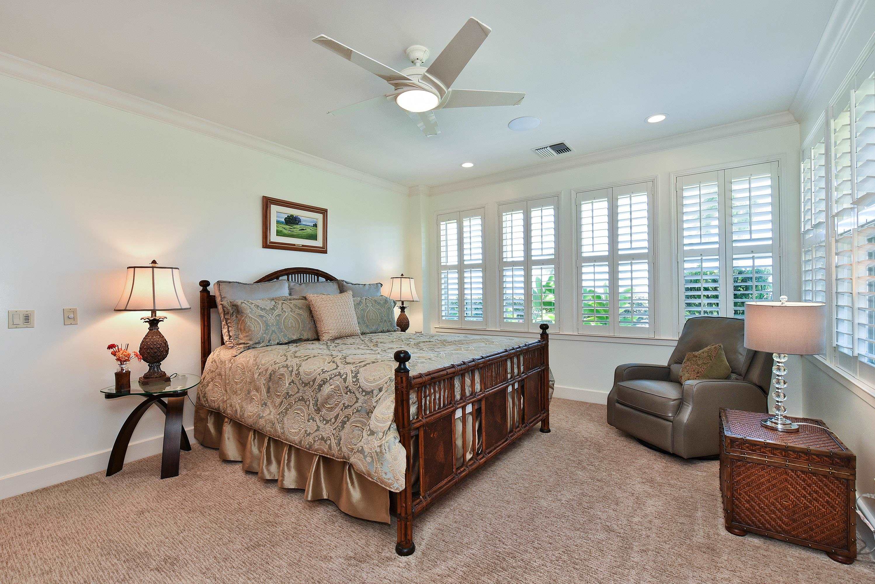 175 Ulukoa Place Lahaina, HI 96761 - Photo 33 of 50 a spacious bedroom with a bed a couch and a chandelier