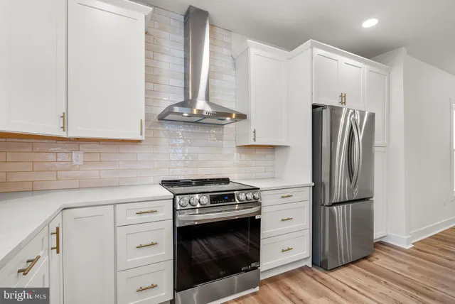 a kitchen with a stove and a refrigerator