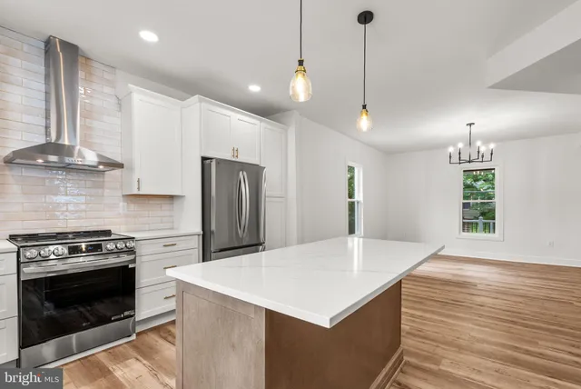 a kitchen with stainless steel appliances granite countertop a refrigerator sink and cabinets