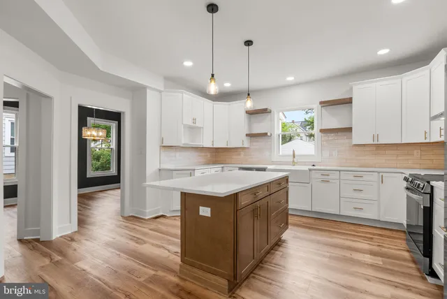 a view of a kitchen with a sink stainless steel appliances and cabinets