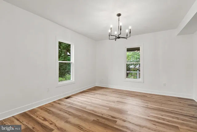 a view of a room with window and wooden floor