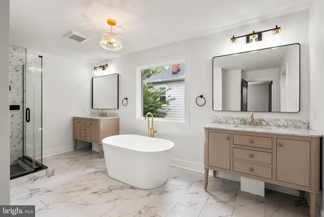 a bathroom with a granite countertop sink mirror vanity and toilet