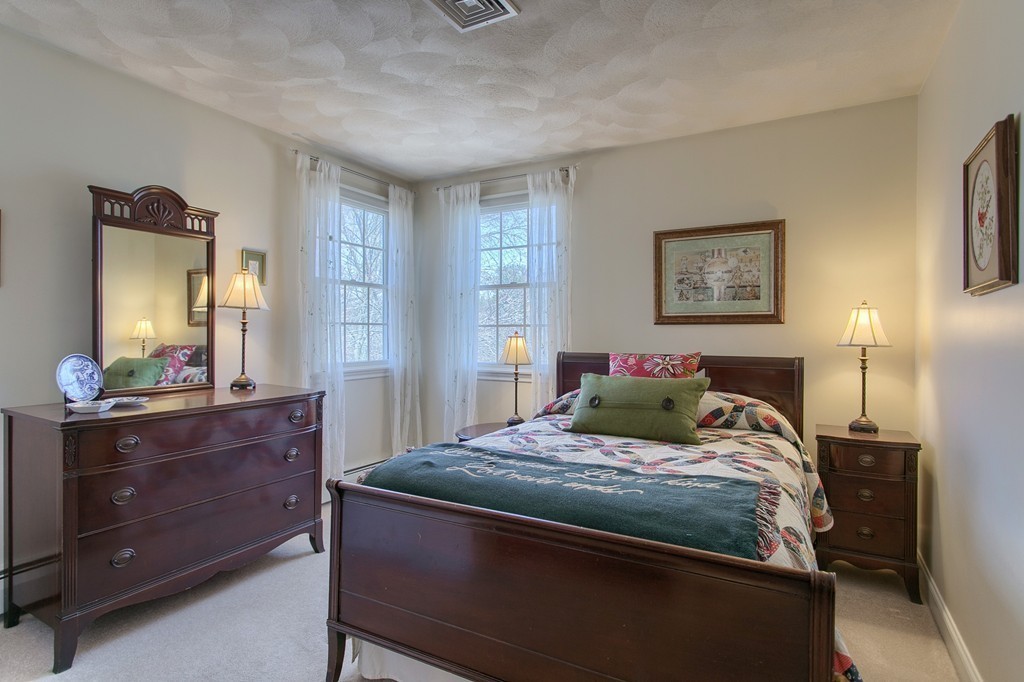 12 Meadow Road Beverly, MA 01915 - Photo 17 of 30 a bedroom with a bed and a mirror on dresser