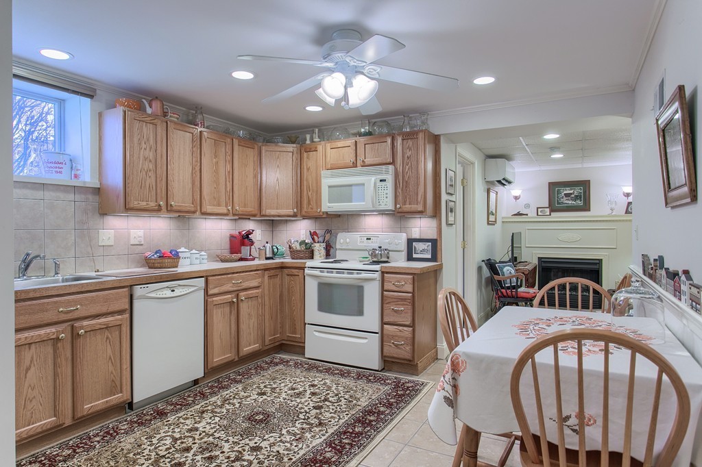 12 Meadow Road Beverly, MA 01915 - Photo 19 of 30 a kitchen with sink cabinets and dining table chair