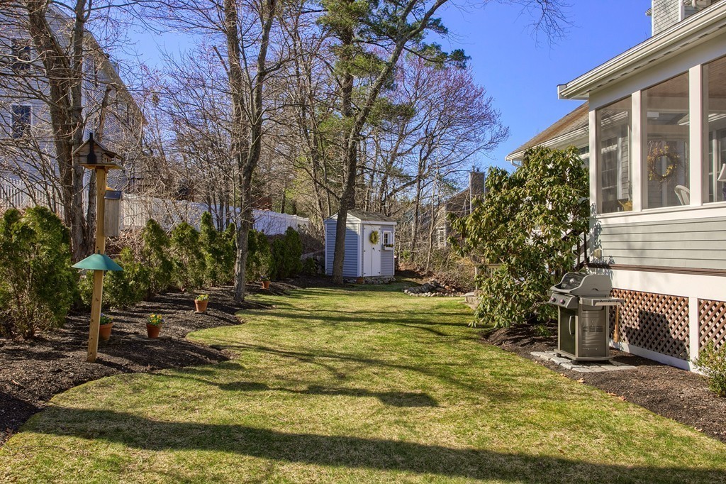 12 Meadow Road Beverly, MA 01915 - Photo 27 of 30 a backyard of a house with a fountain and large trees