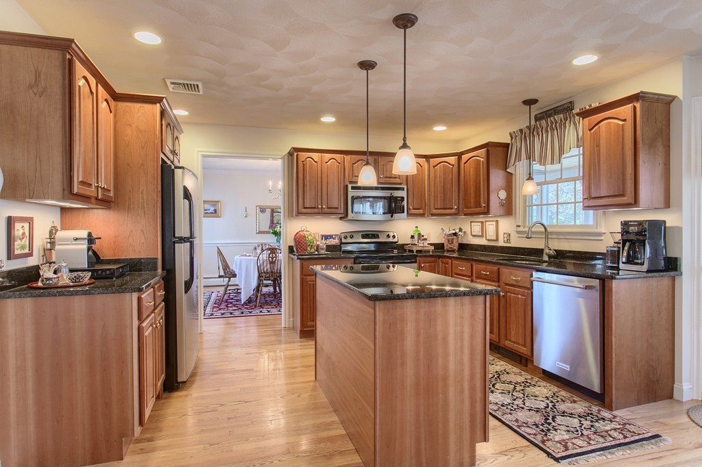 12 Meadow Road Beverly, MA 01915 - Photo 7 of 30 a kitchen with stainless steel appliances granite countertop a sink a stove and a refrigerator