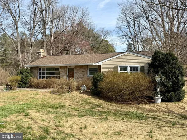 a front view of a house with a yard covered in snow