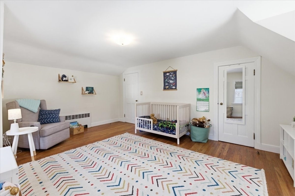 46 Park Street Dedham, MA 02026 - Photo 21 of 35 a bedroom with furniture and a wooden floor