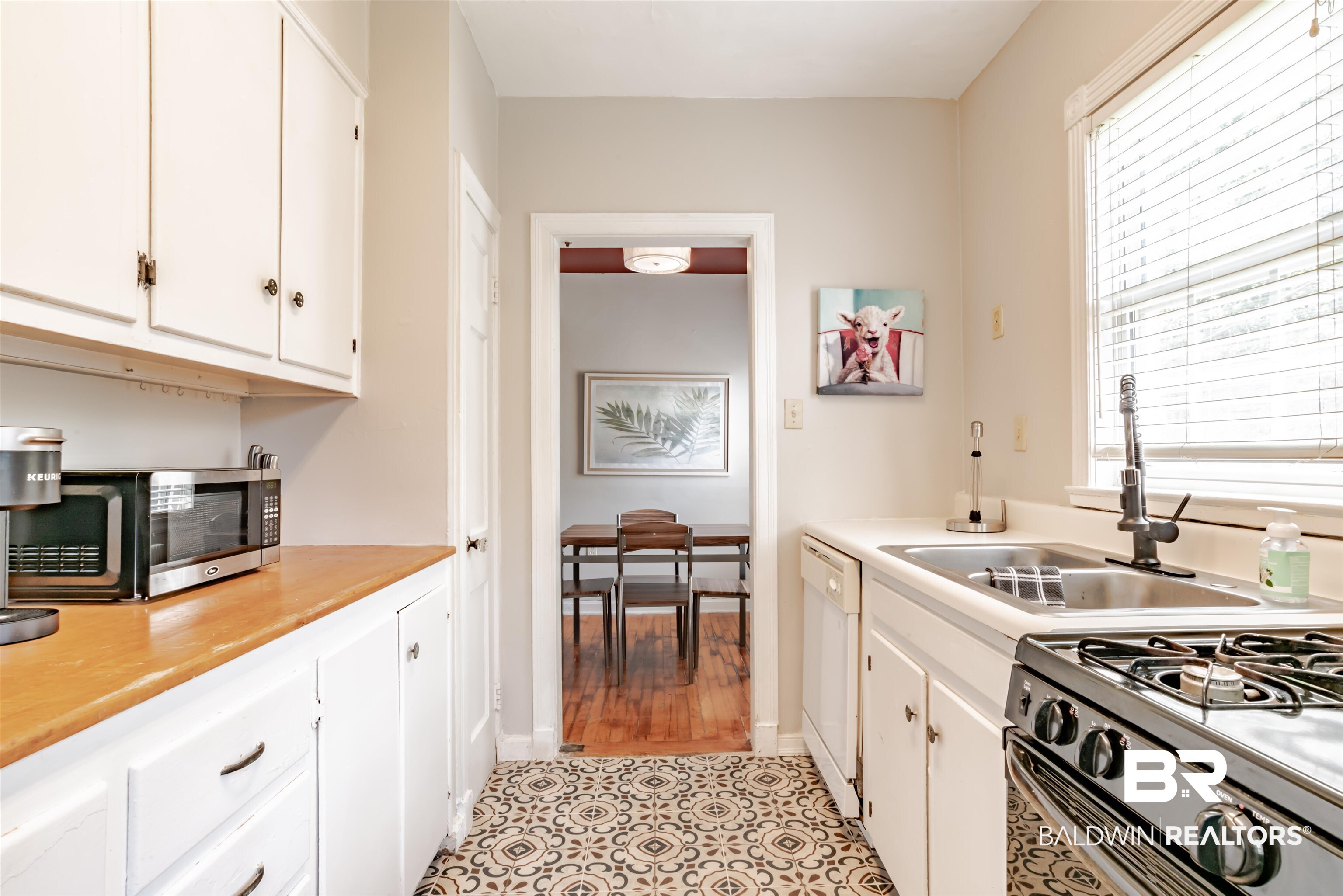 214 Upham Street, Unit 7C Mobile, AL 36607 - Photo 12 of 32 Kitchen with white cabinetry, light countertops, black gas range oven, dishwasher, and light tile patterned floors
