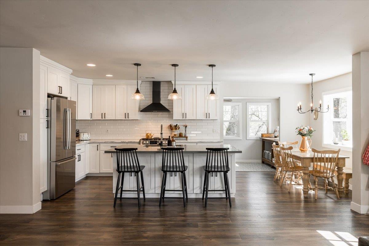 4963 Del Haven Road Placerville, CA 95667 - Photo 11 of 53 a kitchen with stainless steel appliances granite countertop a dining table chairs refrigerator and sink