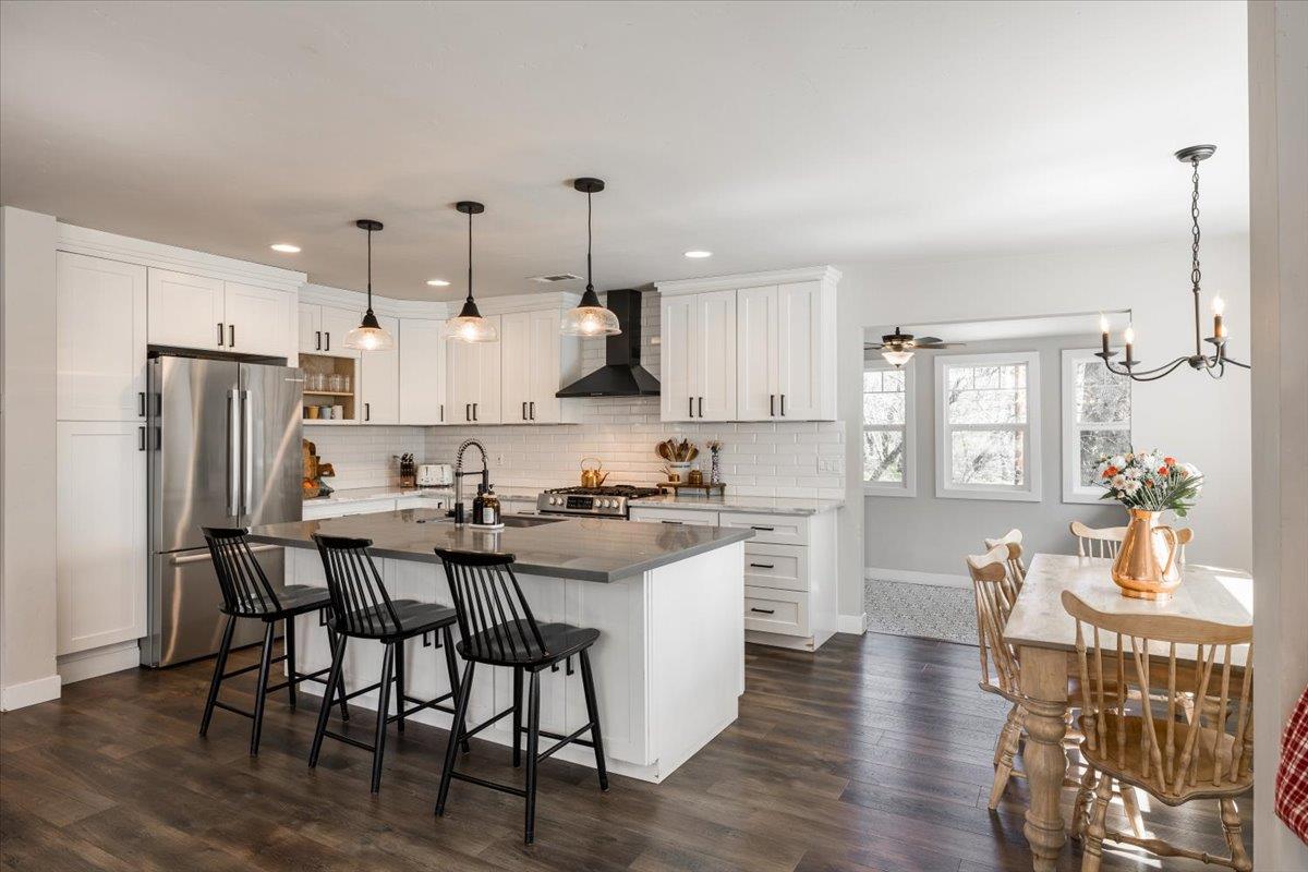 4963 Del Haven Road Placerville, CA 95667 - Photo 13 of 53 a kitchen with stainless steel appliances a table chairs refrigerator and wooden floor