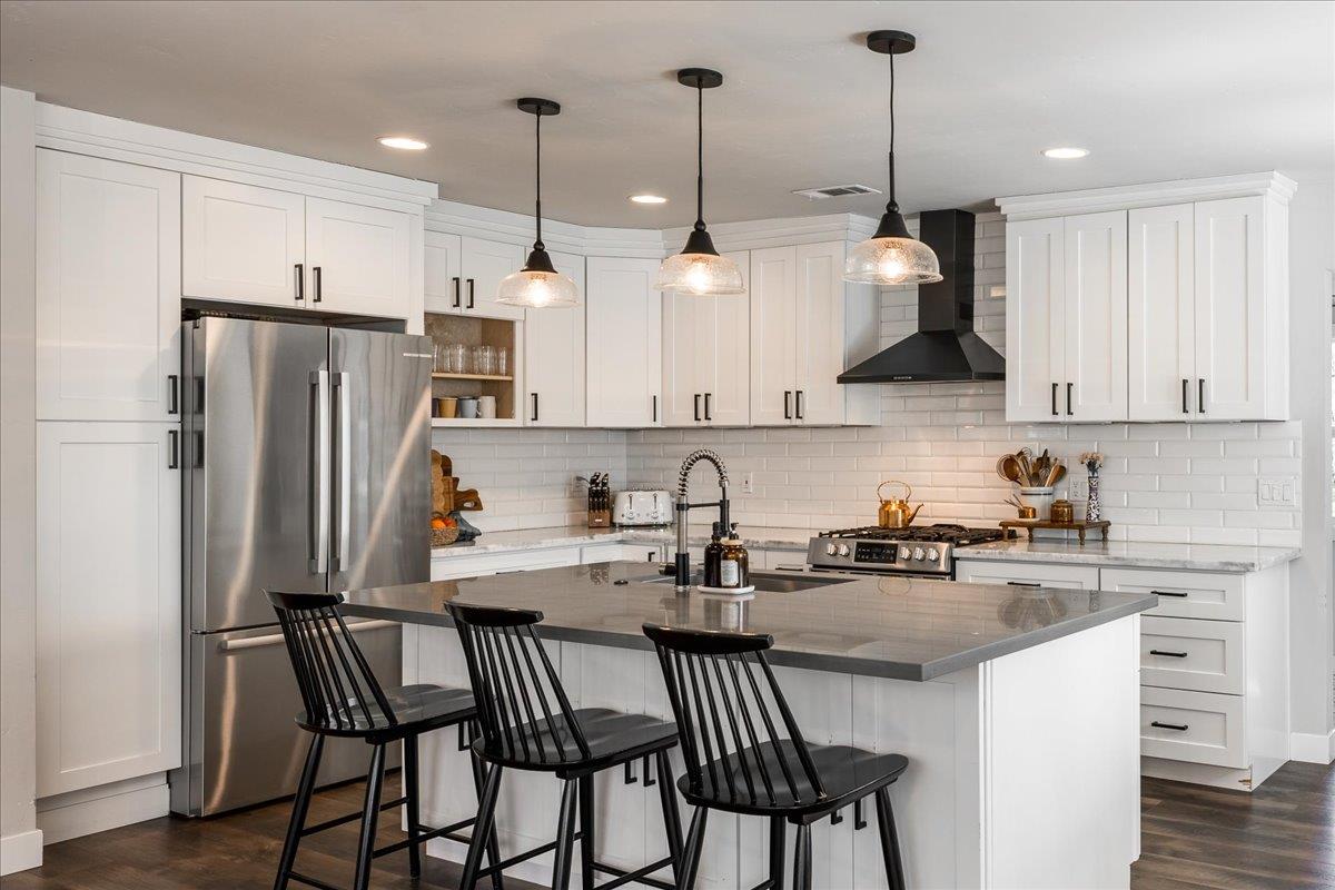 4963 Del Haven Road Placerville, CA 95667 - Photo 14 of 53 a kitchen with stainless steel appliances granite countertop a sink a stove a refrigerator and island with wooden floor