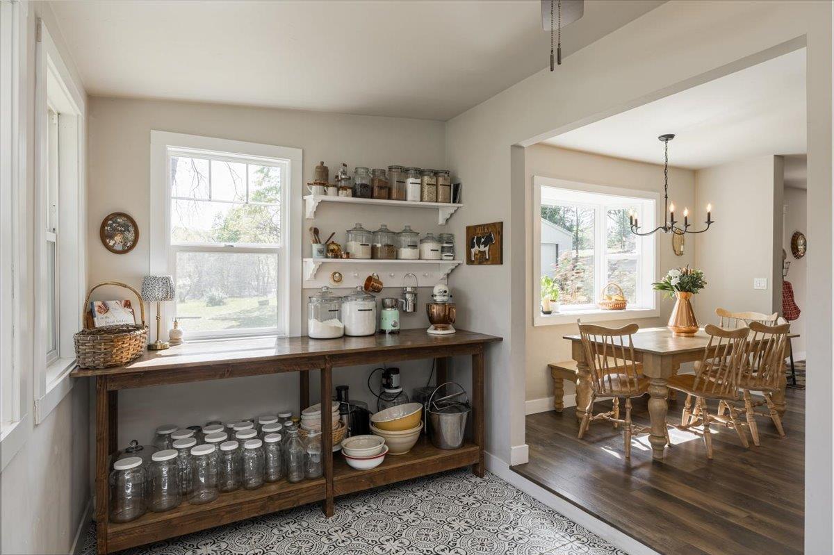 4963 Del Haven Road Placerville, CA 95667 - Photo 20 of 53 a kitchen with stainless steel appliances granite countertop a stove and a view of dining table with wooden floor