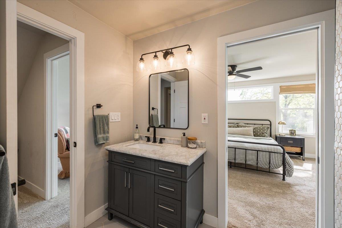 4963 Del Haven Road Placerville, CA 95667 - Photo 29 of 53 a en suite bathroom with a double vanity sink a large mirror and a bathtub