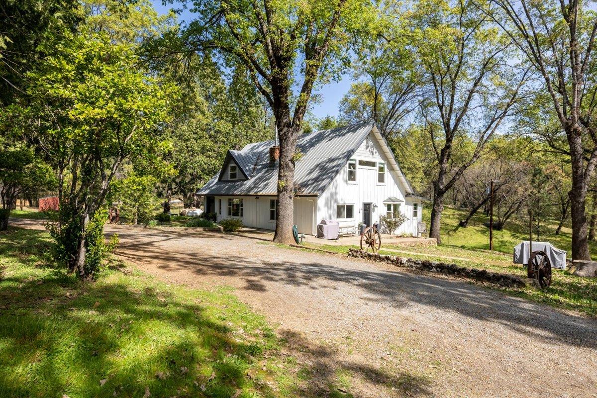 4963 Del Haven Road Placerville, CA 95667 - Photo 3 of 53 a view of a house with a yard covered in the forest