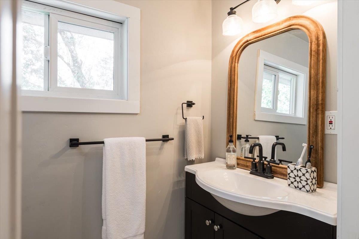 4963 Del Haven Road Placerville, CA 95667 - Photo 35 of 53 a bathroom with a sink a mirror and a window