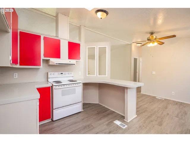 a kitchen with a stove a sink and a window