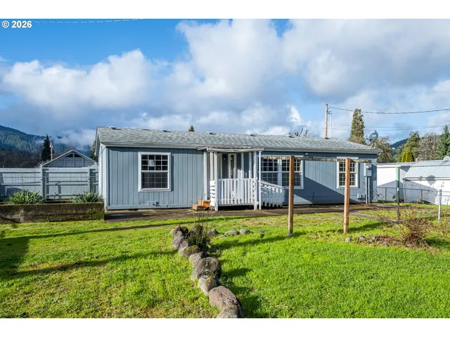 a view of a house with a yard and sitting area