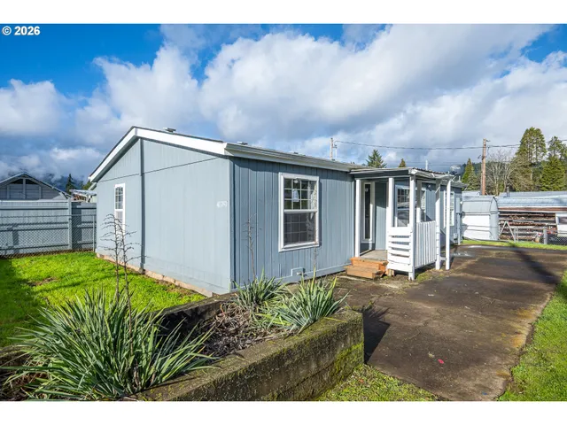 a backyard of a house with table and chairs