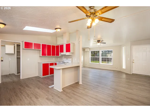 a view of kitchen with cabinets and wooden floor