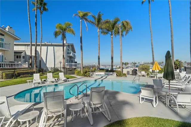 a view of a house with a swimming pool and a yard
