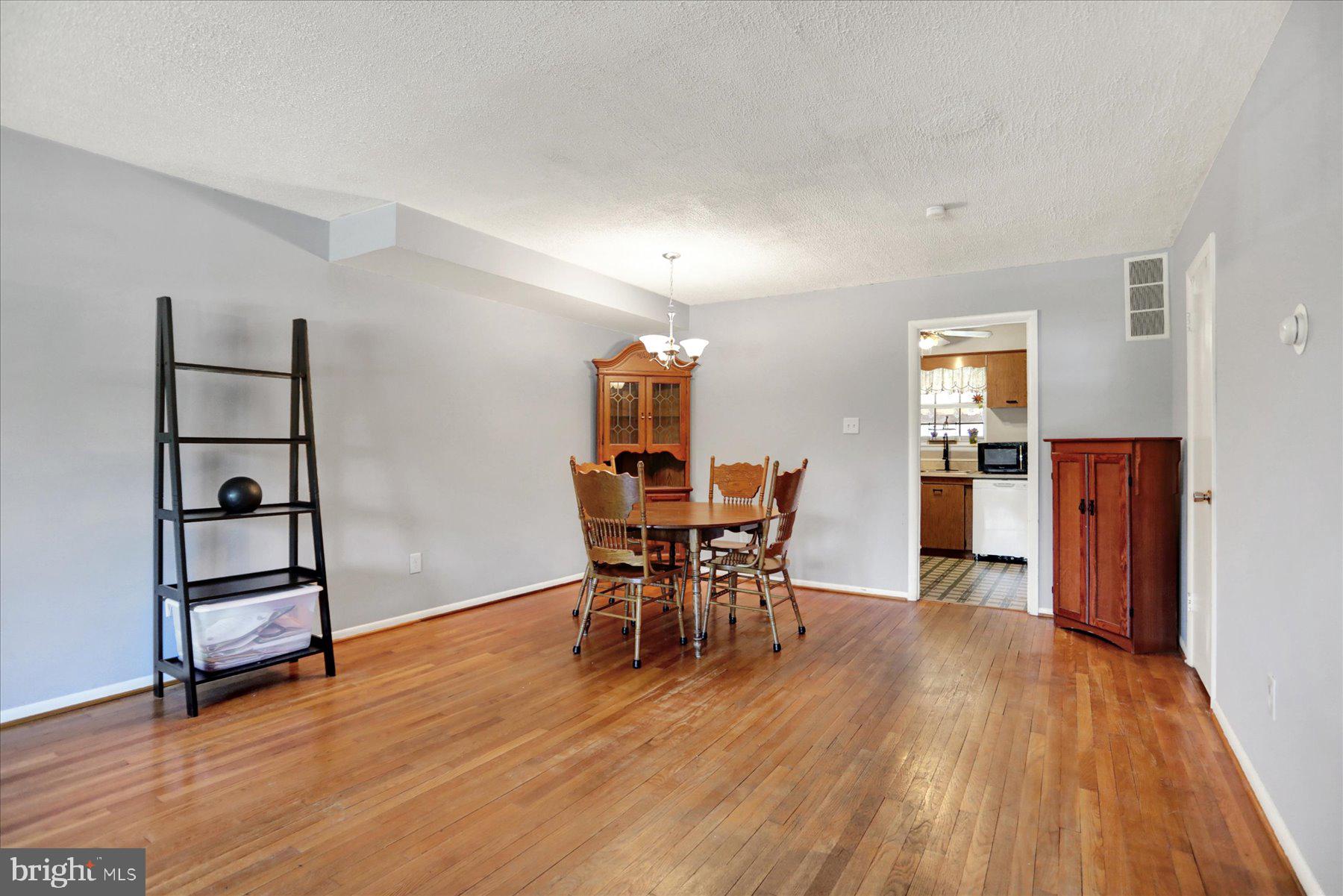 959 Elm Road Baltimore, MD 21227 - Photo 3 of 27 a dining room with furniture and wooden floor