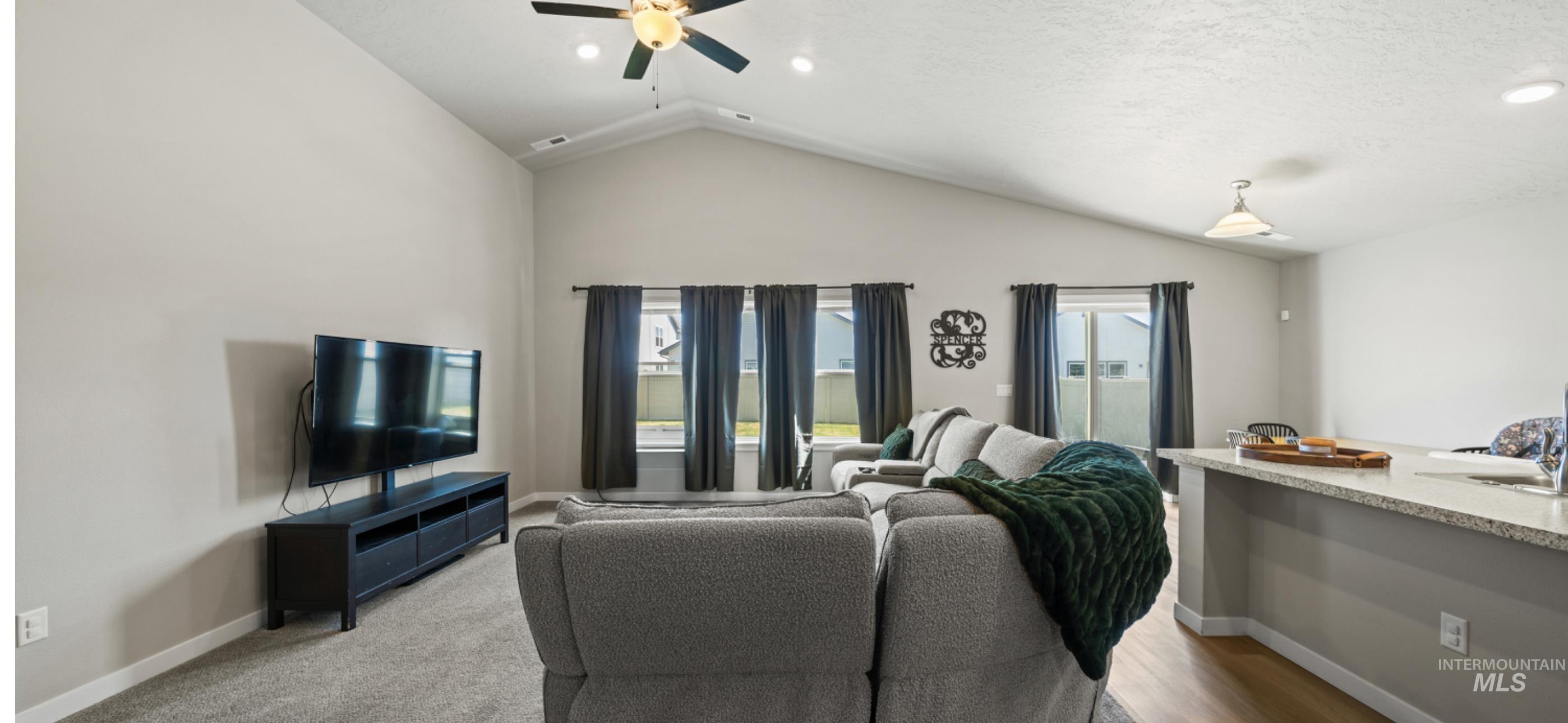 12443 Varga Street Caldwell, ID 83607 - Photo 13 of 27 Living area with a ceiling fan, lofted ceiling, and recessed lighting