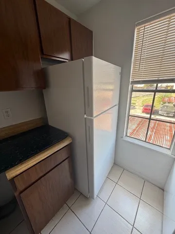 a kitchen with a stove top oven and cabinets